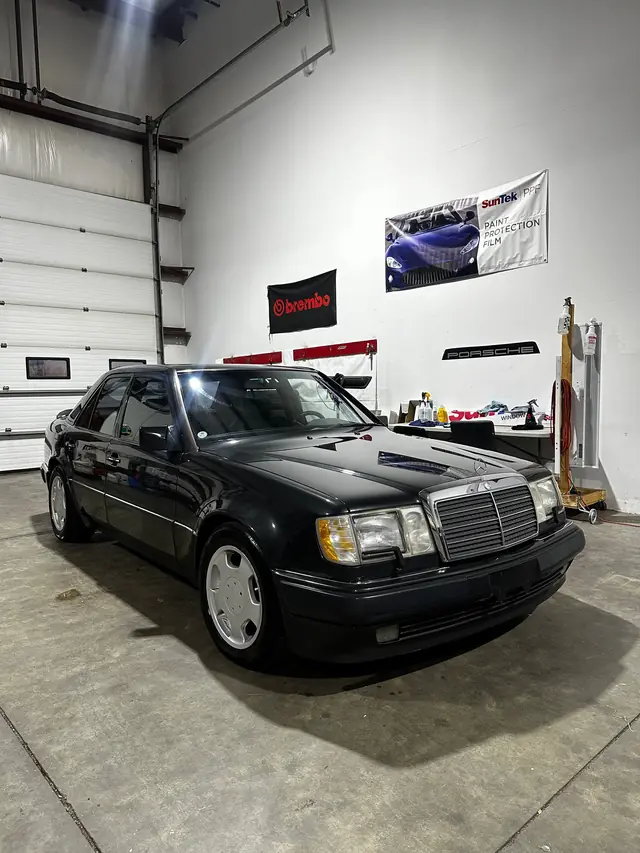 Black Mercedes sedan in the shop