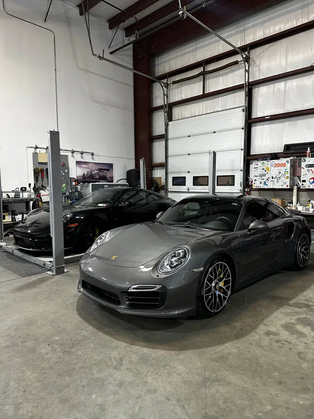 Grey Porsche 911 Turbo raised on the lift