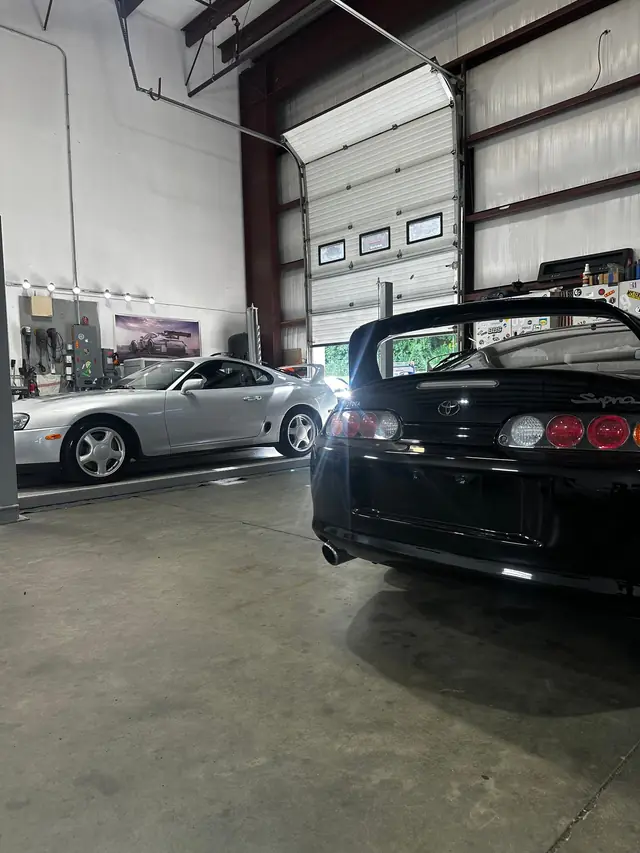 Rear of a black Toyota Supra with dark tinted glass