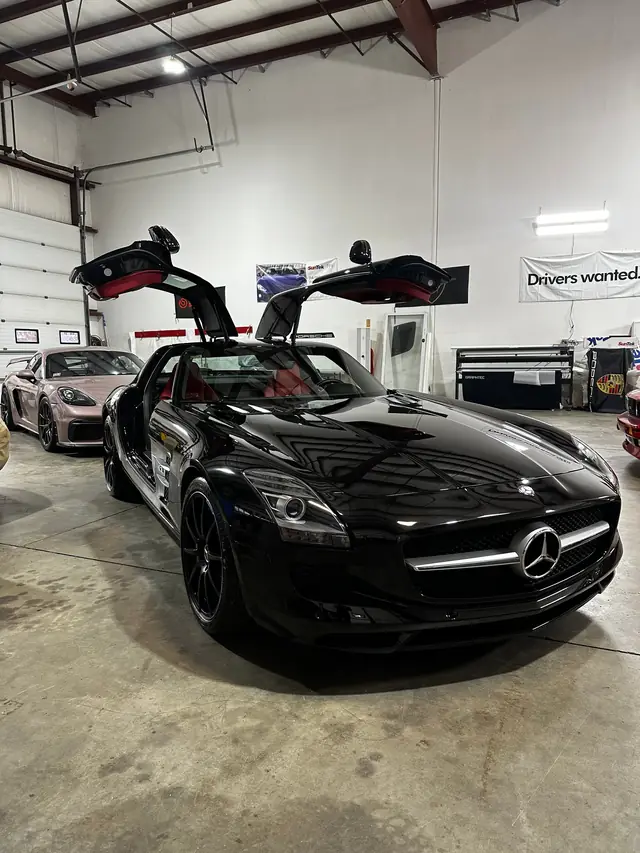 Black Mercedes SLS with gullwing doors open
