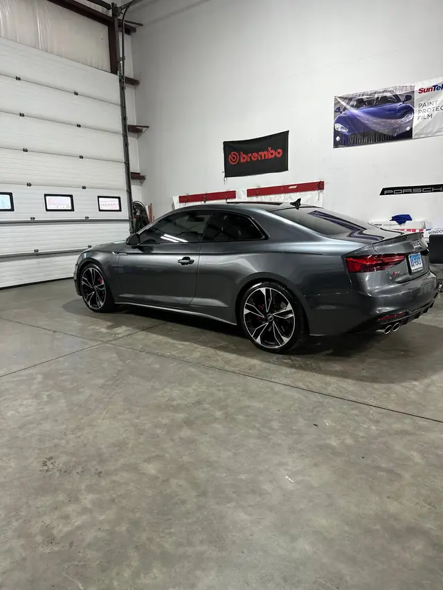 Grey Audi coupe parked in the shop