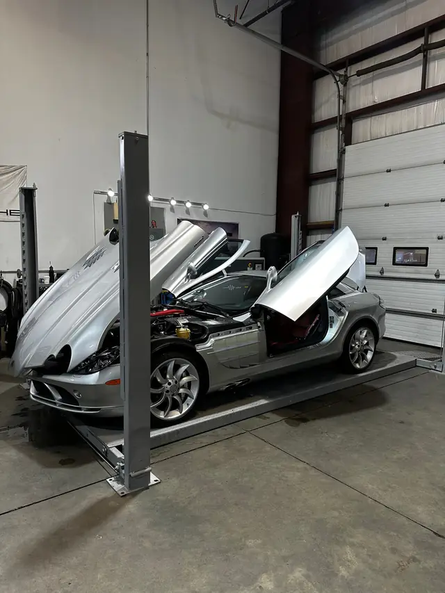 Silver Mercedes SLR with doors and hood open