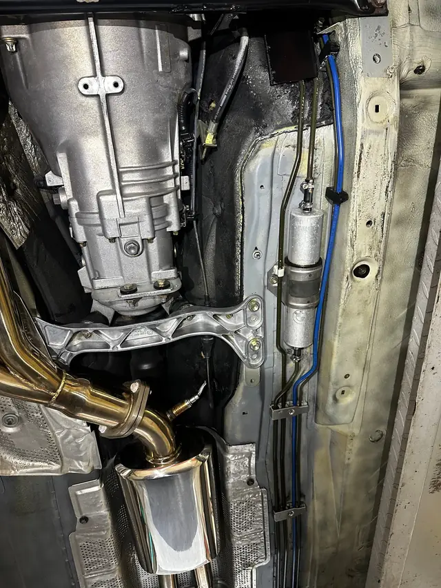 Gearbox and exhaust on the underside of a car up on the lift, Danbury Road bay, New Milford